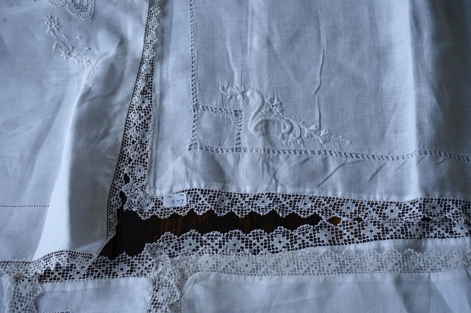 Ten fine linen baby’s pillowcases, eight inset and edged with fillet lace, together with a large fine linen red bordered 19th century ladies kerchief, and three other items. (14) Kerchief 54cm x 58cm. Condition - all ite